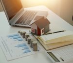 Saving money wealth concept, asian young business woman hand write management budget for saving cost, cash finance planning to spend enough money on her income for save money, payment tax, investing.